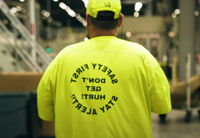 An IP employee wears a bright yellow safety first t-shirt